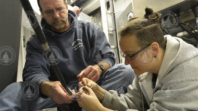Chris Griner and Amy Simoneau test optical fibers at the center of the .681 cable.