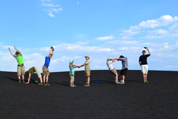 Study Tour participants spelling out "WHOI" by posing with their bodies.