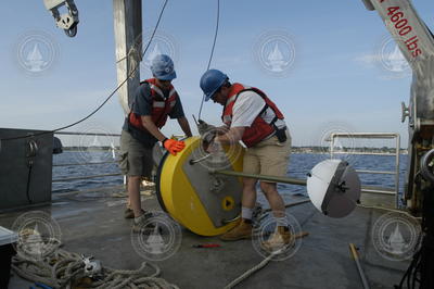 Postdoctoral scholar Dave Ralston and Jay Sisson with a recovered mooring.