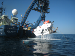 Alvin is lifted up out of the water by Atlantis a-frame during recovery operations.