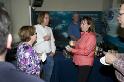 People enjoying the reception at the Exhibit Center after the colloquium.