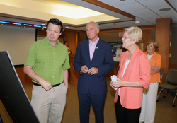 John Collins briefing Sen. Warren and Rep. Keating on his research.