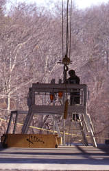 A person in Clark South high bay installing sensors on buoy.