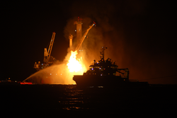 Nighttime view of natural gas burning off in the Gulf of Mexico.