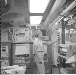 Betty Bunce adjusting dials on equipment in Atlantis II computer lab.