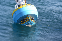 Underside of Global Surface Mooring buoy visible during deployment.