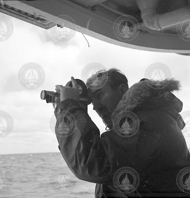 Photographer Jan Hahn on board R/V Atlantis II with a camera.