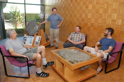 Scientists sitting around sectioned pillow lava displays in Clark Lobby.