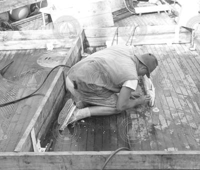 Unidentified man with fish on deck of the Anton Bruun