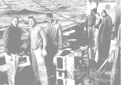Warren Witzell (left) and Betty Bunce (second from right) working on deck of Chain.