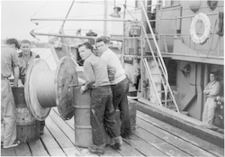 Men working on dock, during Trade Wind cruise
