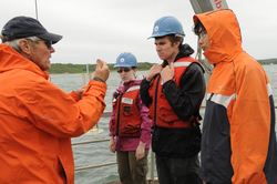 George Hampson showing student different water testing techniques.