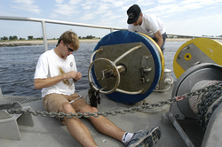 Malcolm Scully, a postdoctoral investigator, works on a recovered mooring.