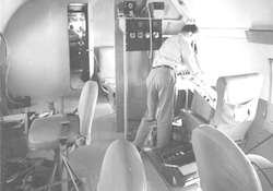 Interior view of C54Q aircraft, unidentified man working on board