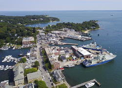 Aerial of Woods Hole village with WHOI's 3 vessels at the dock.