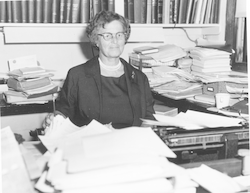 Mary Sears posing for a photo from behind her desk