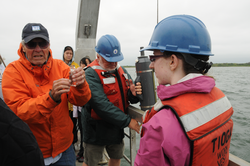 George Hampson teaching students how to get a perfect water sample.