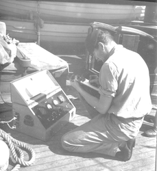 Gene Krance working on current meter on deck of Atlantis