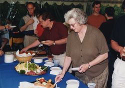 People engaged at the buffet at the 1998 Graduate Reception.