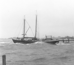 Sailboat docked in Woods Hole during the hurricane of 1938.