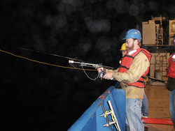 Ken Buessler and Jim Valdes using a crossbow with a grapple to recover an NBST.
