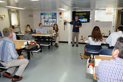 R/V Sikuliaq officer talking to the NSF tour group in the ship's mess.