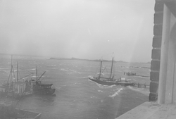 Reliance on right at dock, rough seas in Woods Hole.