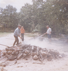 Mike Kelley, Jack Scharff, and Dave Simoneau putting water on clambake fire