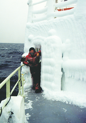 First mate George Silva next to a bulkhead door covered with ice.