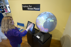 Kathy Patterson with the Magic Planet at the Exhibit Center.