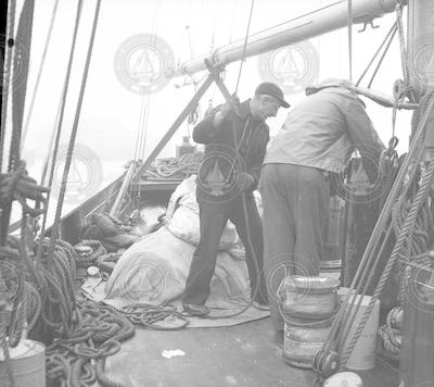 Ted Howell and bosun loading supplies on Caryn.