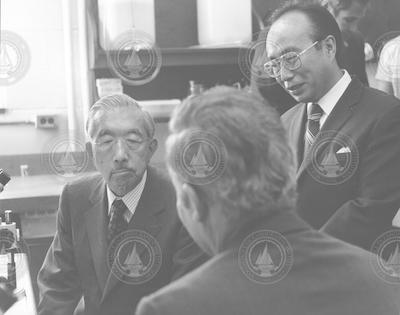 Emperor Hirohito, left, talking with Howard Sanders and Susumu Honjo.