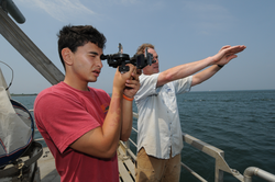 Ken Houtler (right) teaching PEP student Jordan Aoyaman sextant skills.