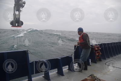 Glen Gawarkiewicz with CTD LARS extended over the surface during rough seas.