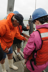 George Hampson teaching students how to get a perfect water sample.