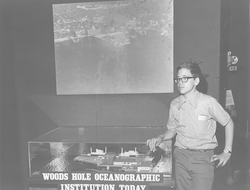 Young Bill Lange standing in the Hangar Exhibit Center.