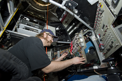 Korey Verhien working inside the Alvin personnel sphere during disassembly.