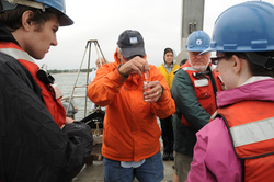 George Hampson teaching students how to get a perfect water sample.