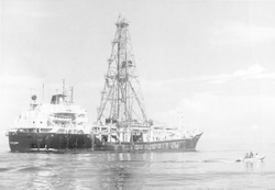 Full view of Glomar Challenger, small boat to side