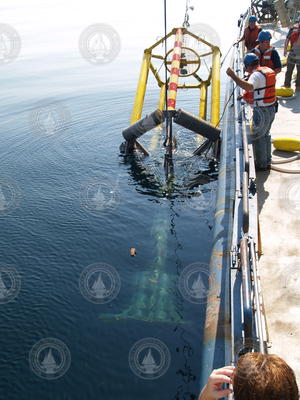 Scientists and crew recovering the spar buoy.