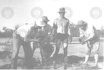 P. Bermudes, H. Rivero, D. Bumpus and H. Mandly in the mud