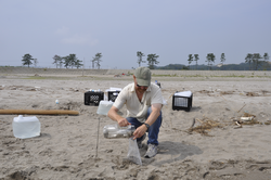 Ken Buesseler sampling beach sand along the Fukushima coast of Japan.