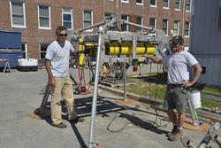 Peter Traykovski and Jay Sisson pose with a "QuadPod" on the WHOI dock.