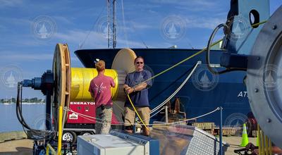 3rd mate Chris Mannka and Chris Griner loading HICO line onto ship winch.