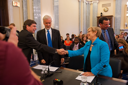 Subcommittee chair Mark Begich greeting Susan Avery.