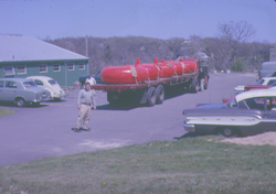 Flatbed trailer with buoy bases in Blake Building parking lot.