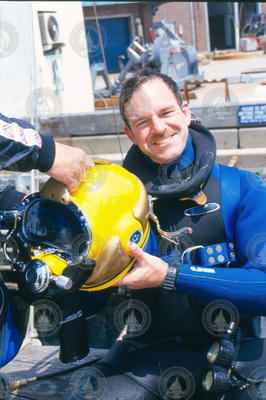 Glenn McDonald with diving gear at the WHOI dock