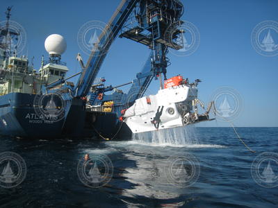 Alvin is lifted up out of the water by Atlantis a-frame during recovery operations.