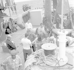 Alfred C. John, John Beckerle, and group working together on deck of Chain