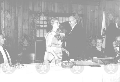 Buck Ketchum pinning corsage on Martha Redfield.